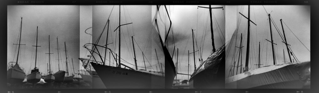 a picture taken in black and white of sailboats in a harbor
