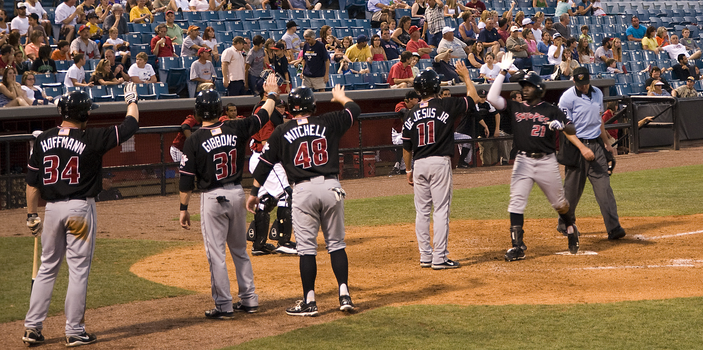 a bunch of baseball players stand on the field