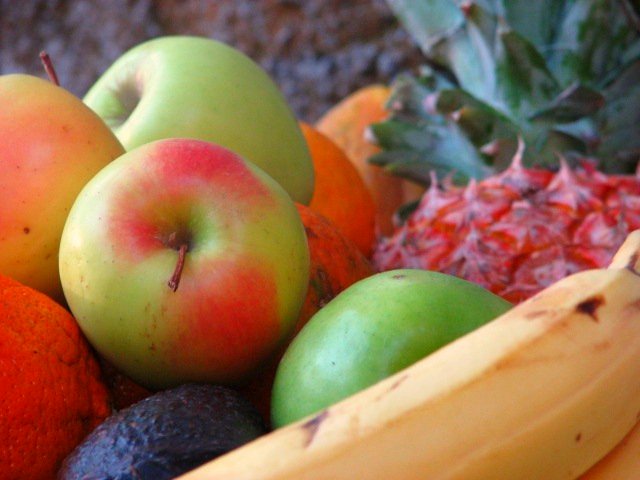 a close up of a bowl of various fruits