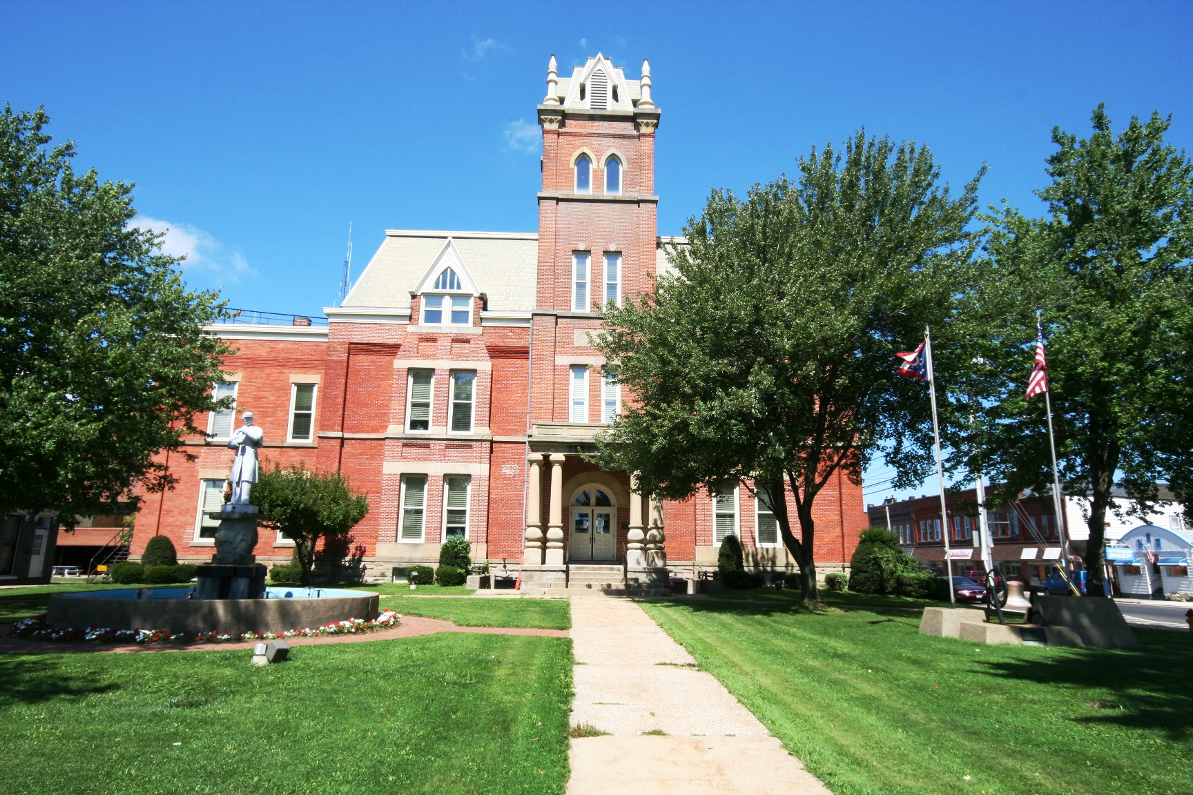 an old red building is in front of some trees