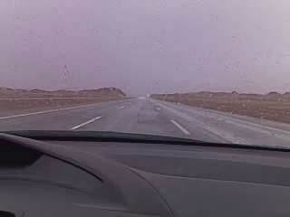 looking at the distance from a car, with some rain on it