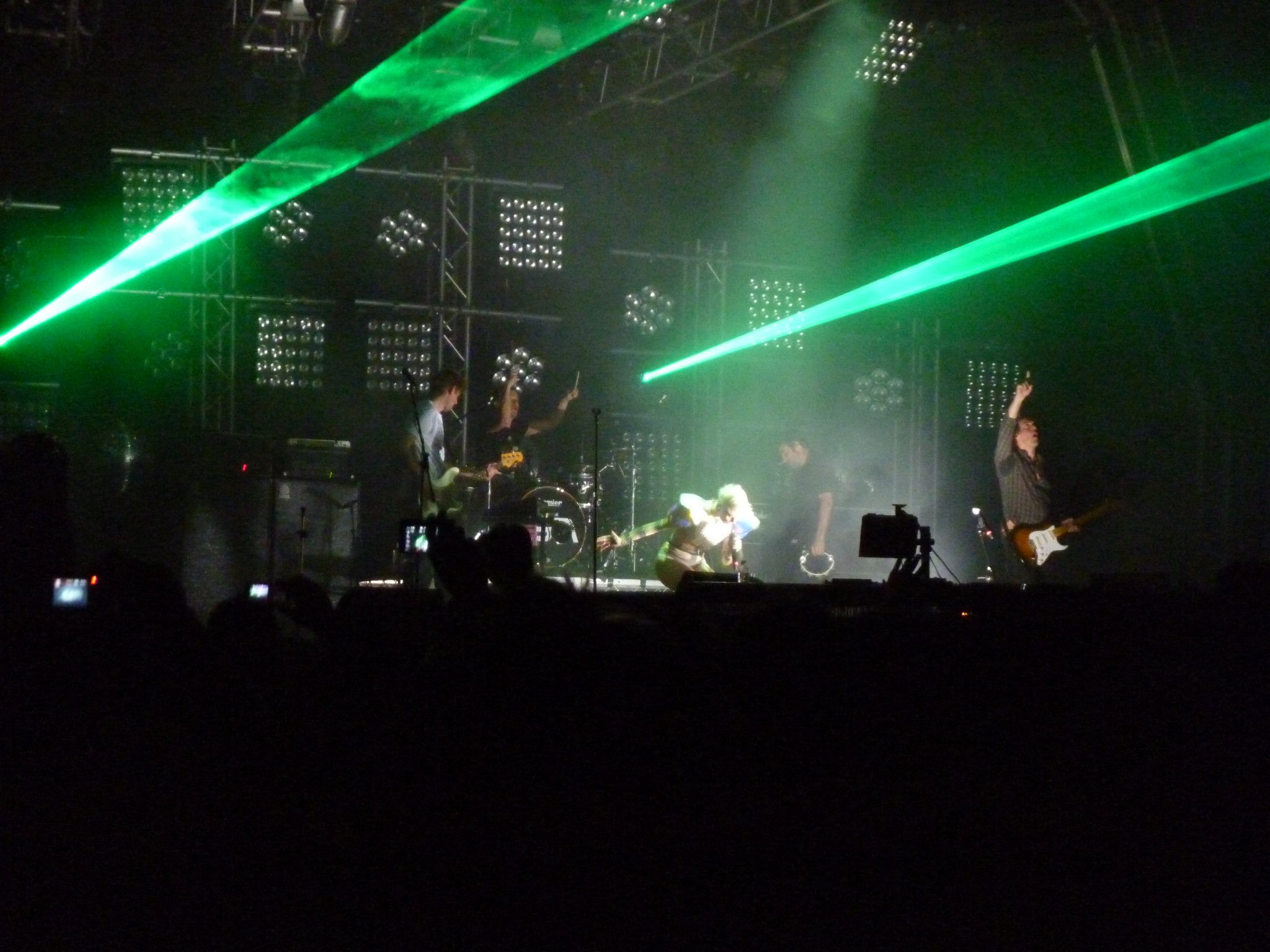 people at a concert with their guitars in front of them