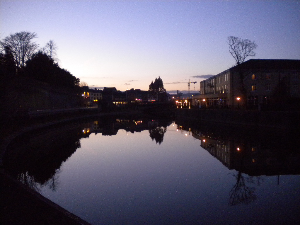 a river running through a small town at night