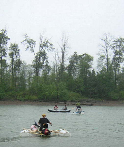 people are in the water with rowing rafts on a cloudy day
