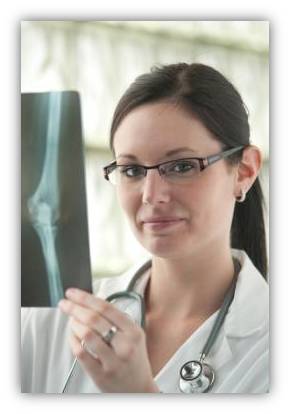 a woman with glasses holding a x - ray in her hands