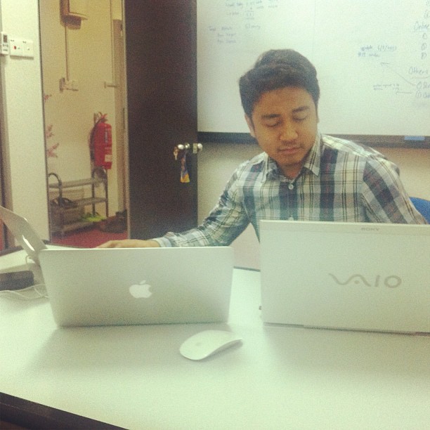 a man is using an apple laptop on a desk