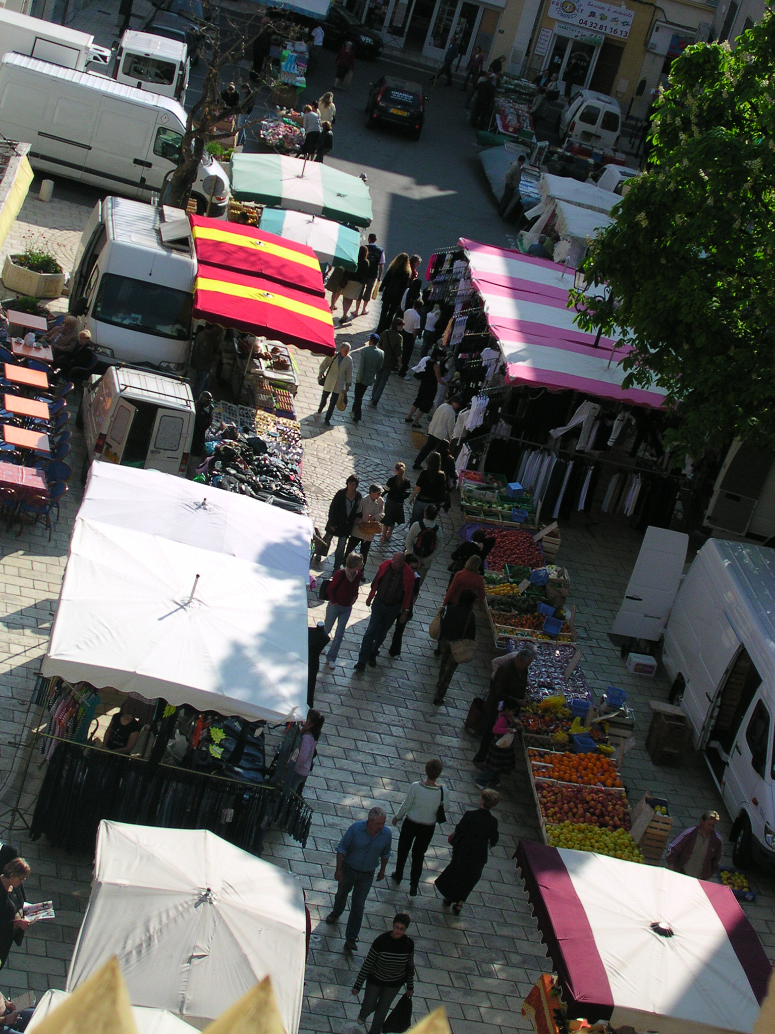the large open air flea market in the town has many tents, vendors and vendors on it