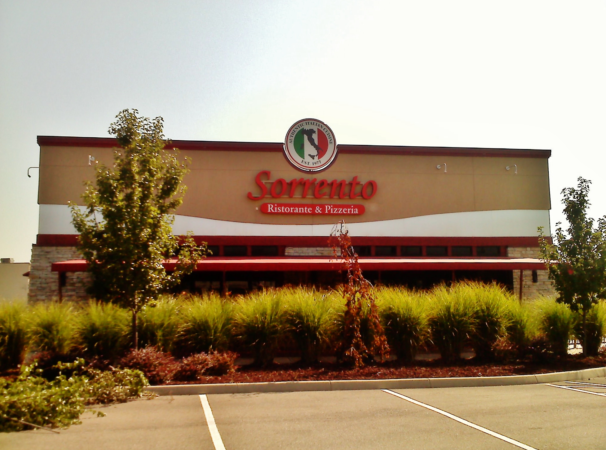 a building with landscaping next to it that has a large sign on the front