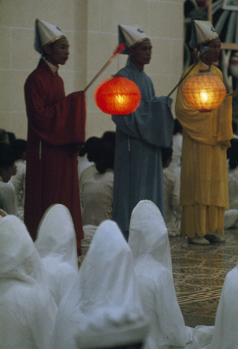 two monks standing and one holding a lantern