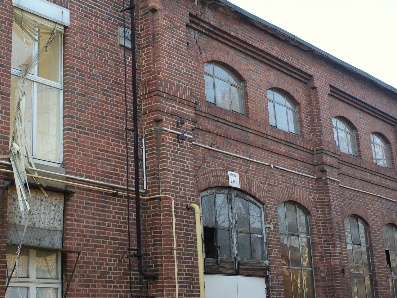 a red brick building with a door open