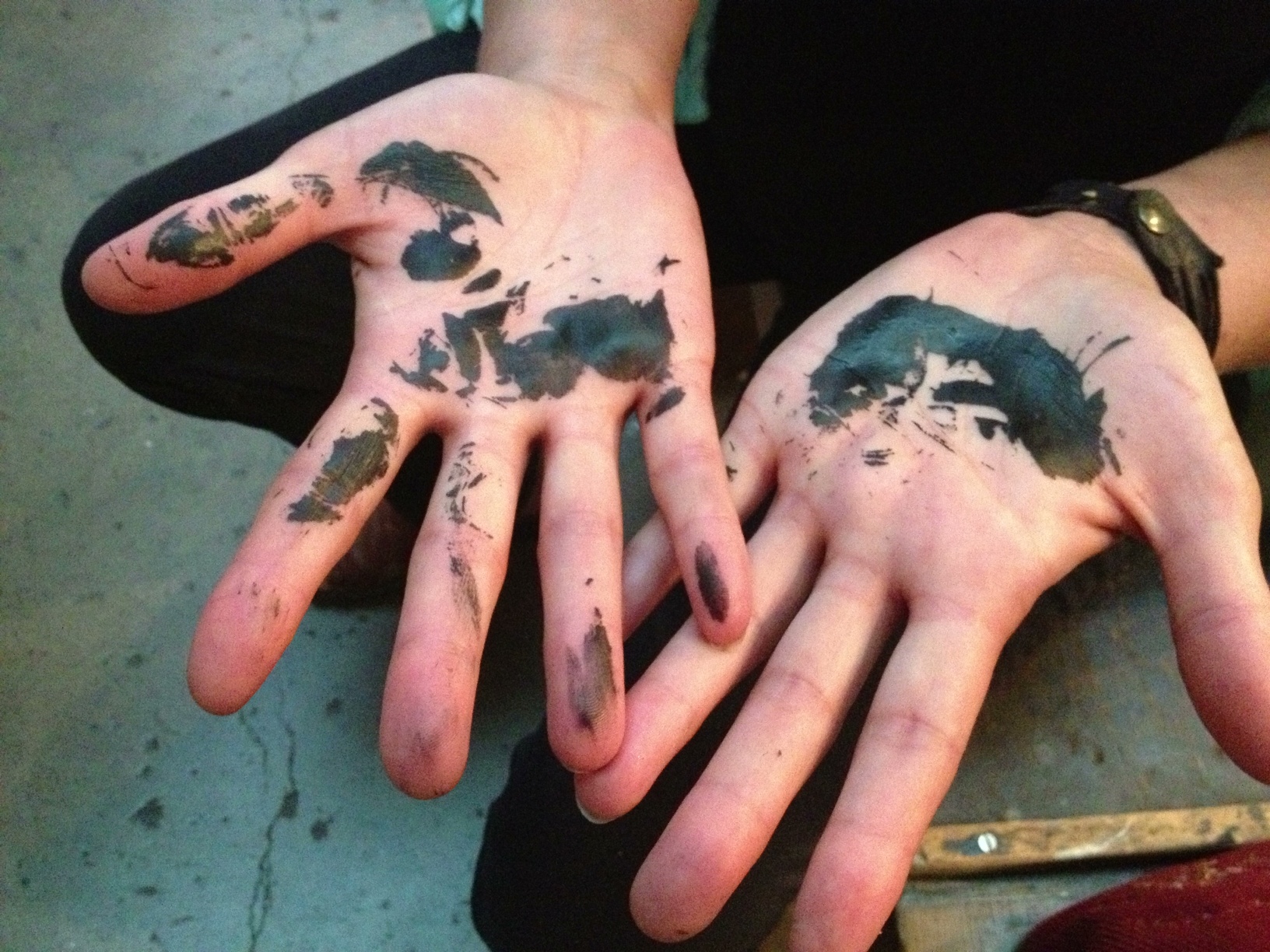 a person with their hands painted black and white