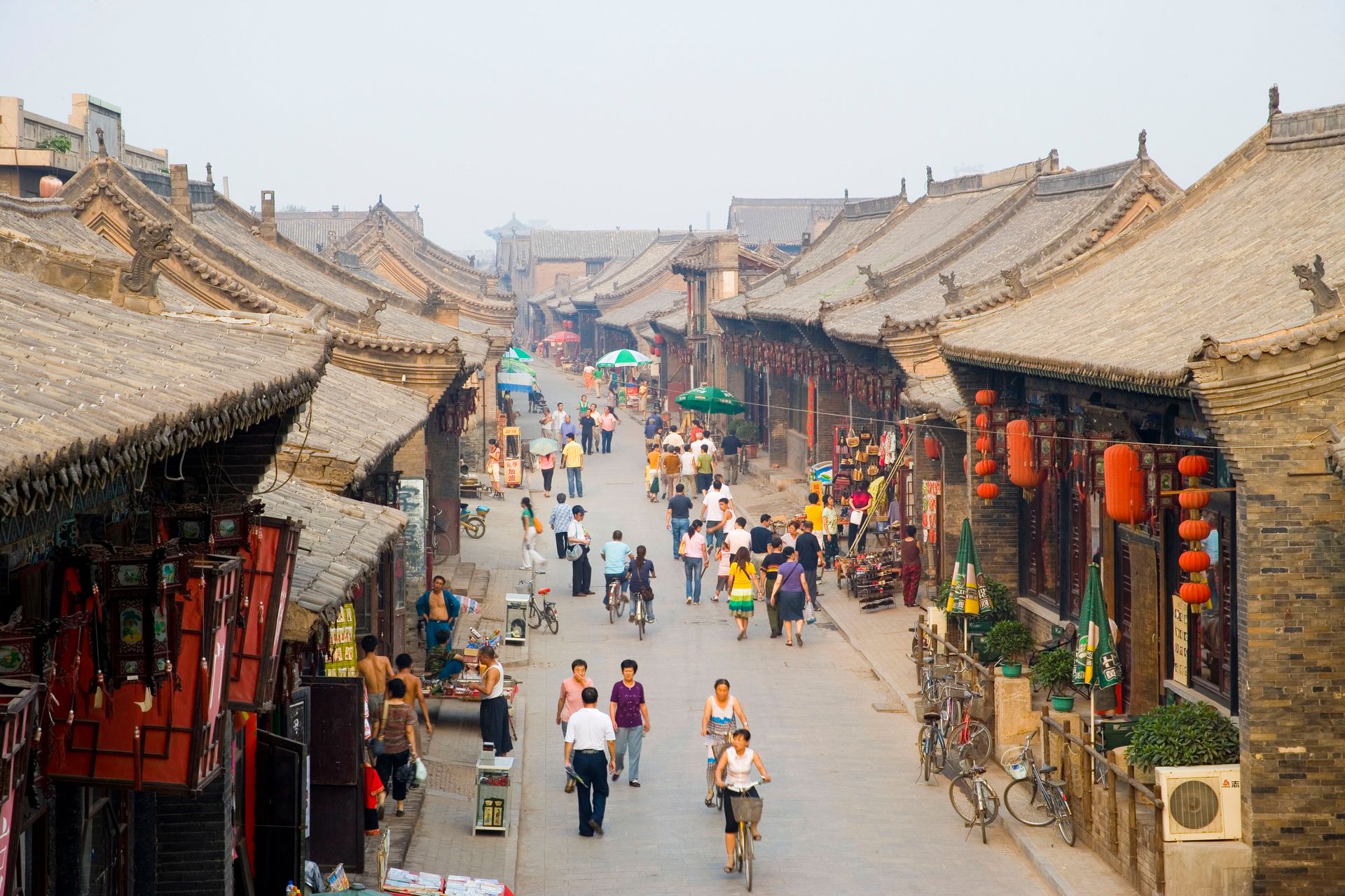 a city street with people walking around and shops