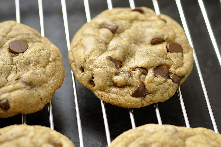 three chocolate chip cookies on a wire rack