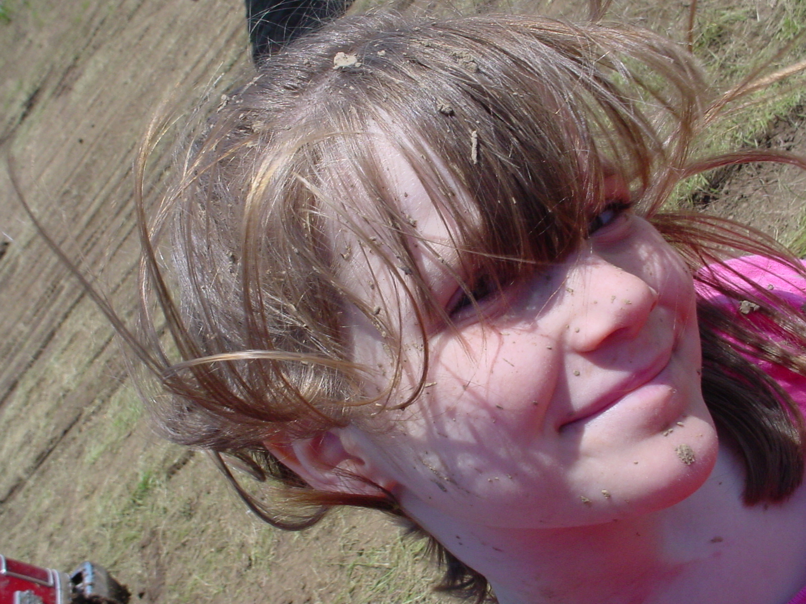 a young child with frecks on her face, looking up