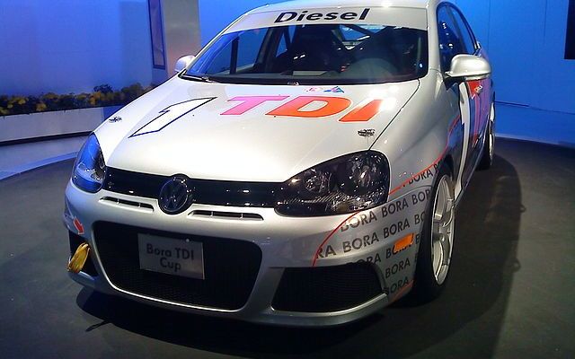 a large white car with an orange logo on it