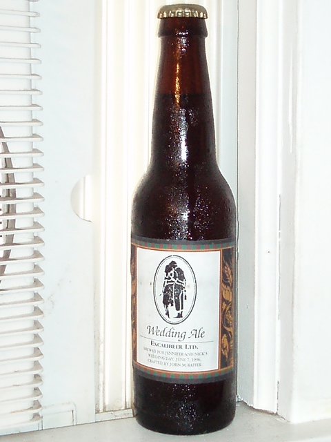 a brown bottle of beer sitting on a window sill