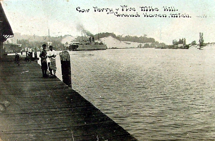 a group of people standing on the side of a pier next to the water