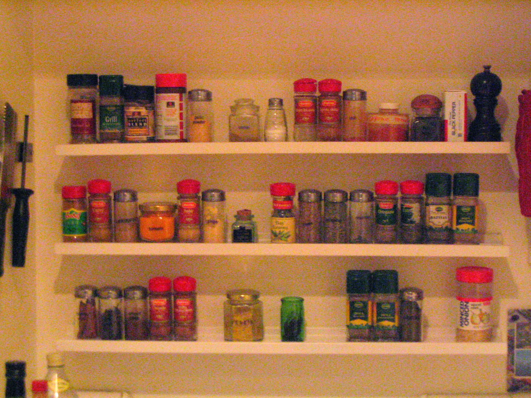 the shelves are filled with different types of spices