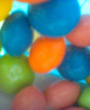 blue and orange jelly beans arranged in a circle