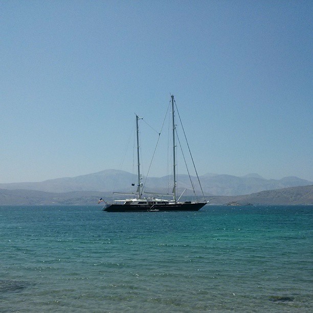 sailboat out in the open ocean near shore