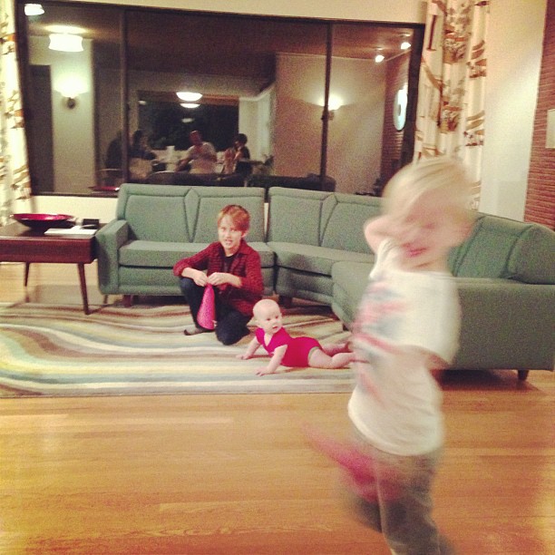 a child with a walker, playing in a living room