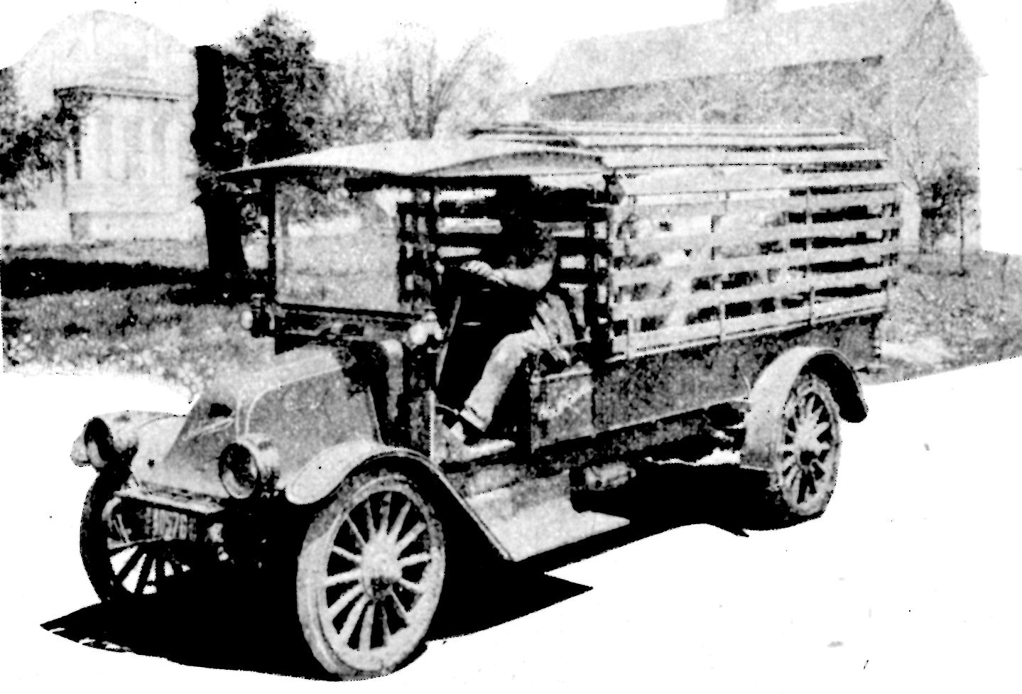 an old truck sitting parked on the side of the road