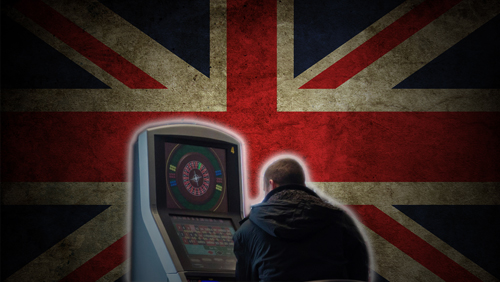 a man playing a video game in front of the union jack symbol