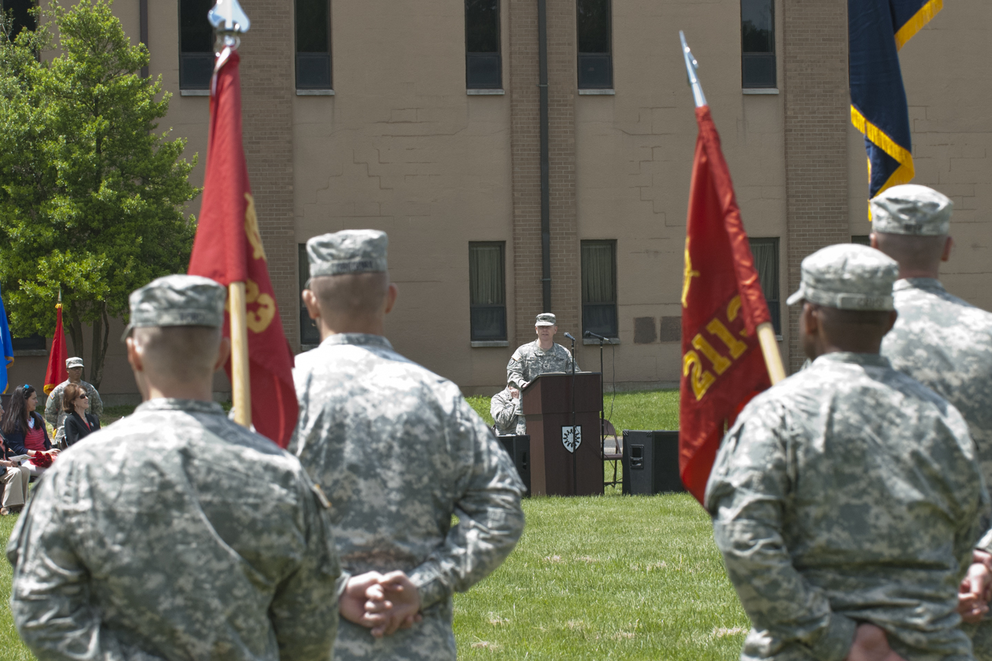 men in uniforms are holding flags at a military ceremony