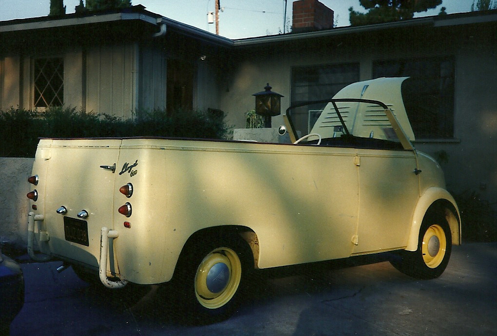 an old style truck parked in front of a house