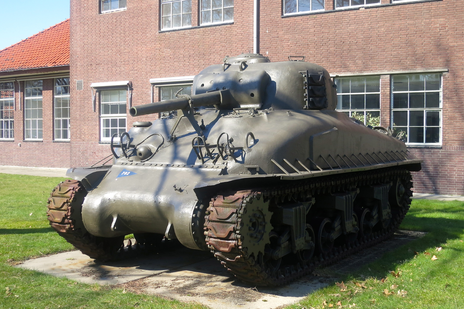 a camouflaged army tank is shown in a courtyard