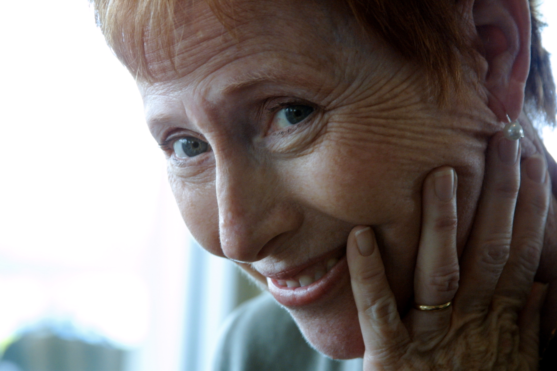 an older woman with short hair looking into the camera