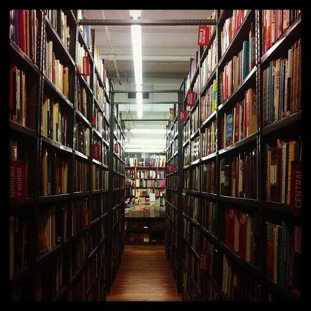 an aisle in the middle of a large book store with many books on shelves