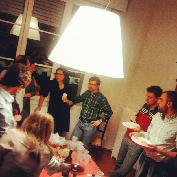 several people in a kitchen and a man serving food