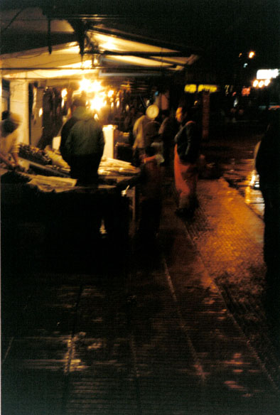 many people at a market standing around