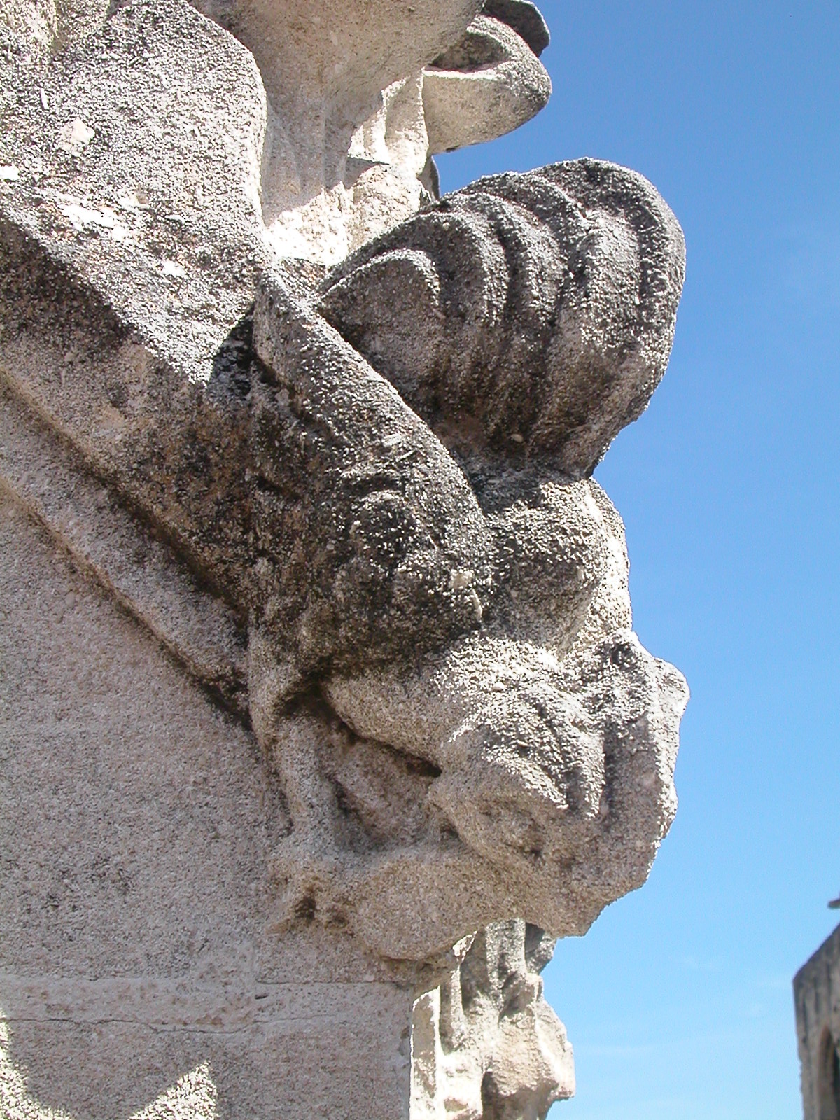 a tall white building with sculptures on it