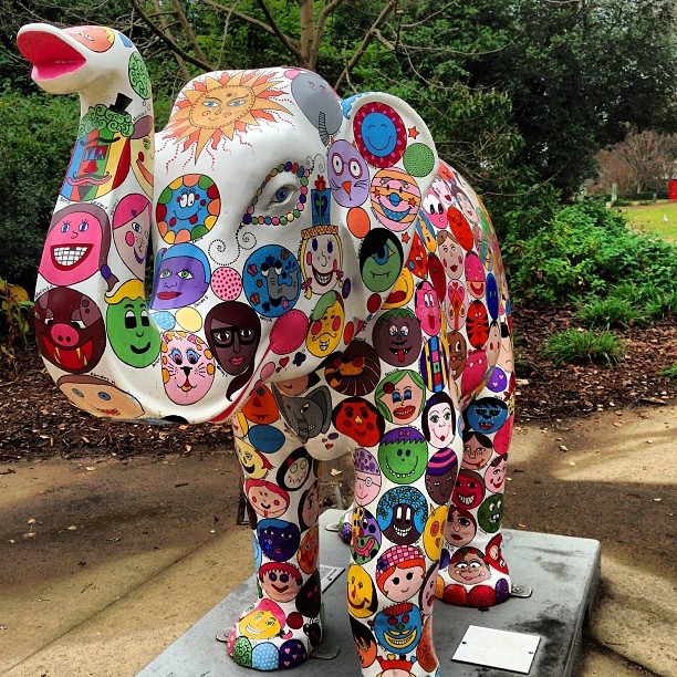 an elephant is adorned with many faces and pictures
