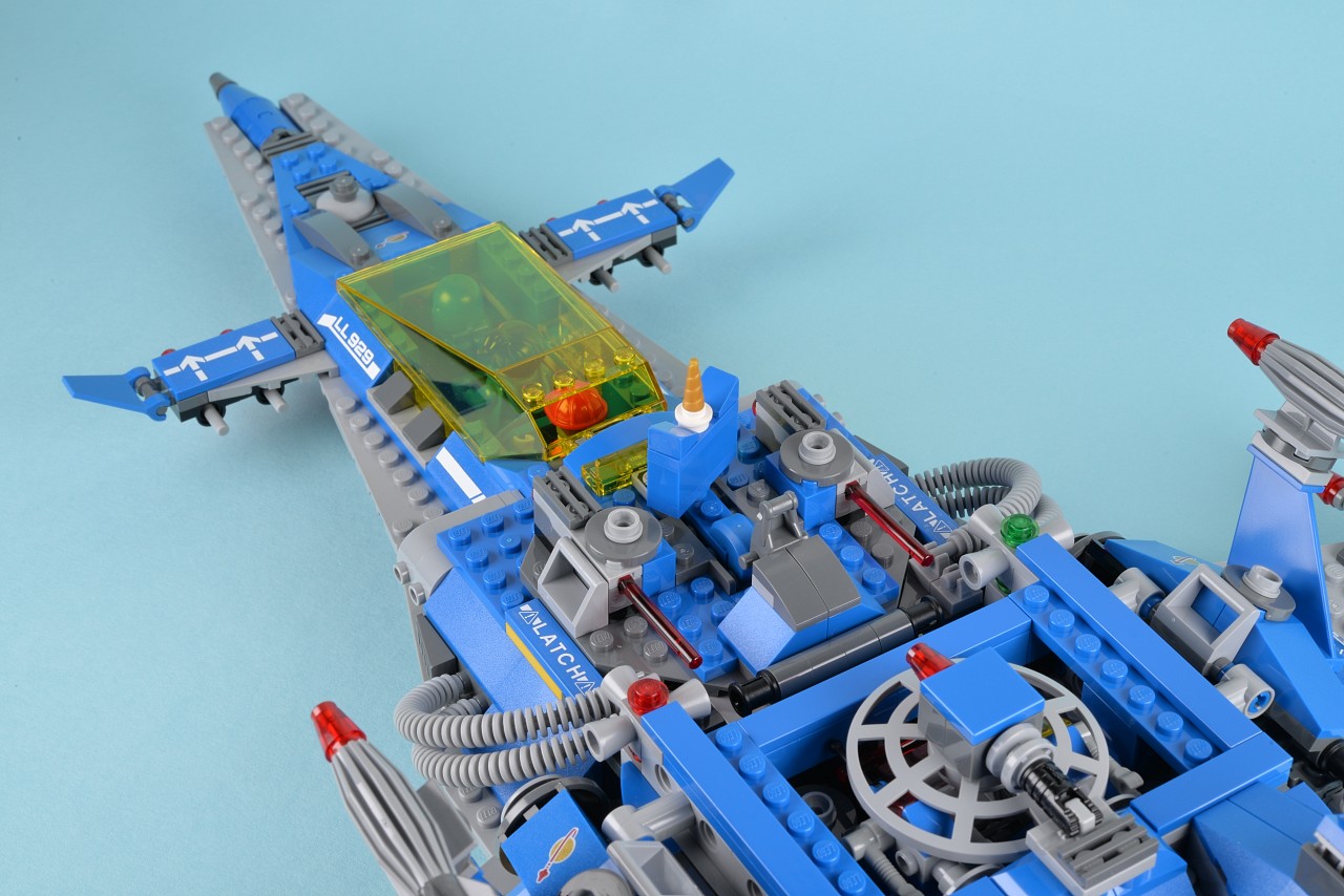 a toy airplane is shown on a blue surface