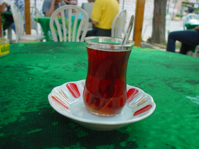 a cup of tea sitting on top of a white plate