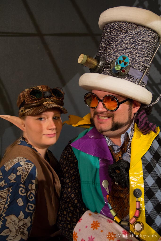 two people wearing costumes with a hat and glasses