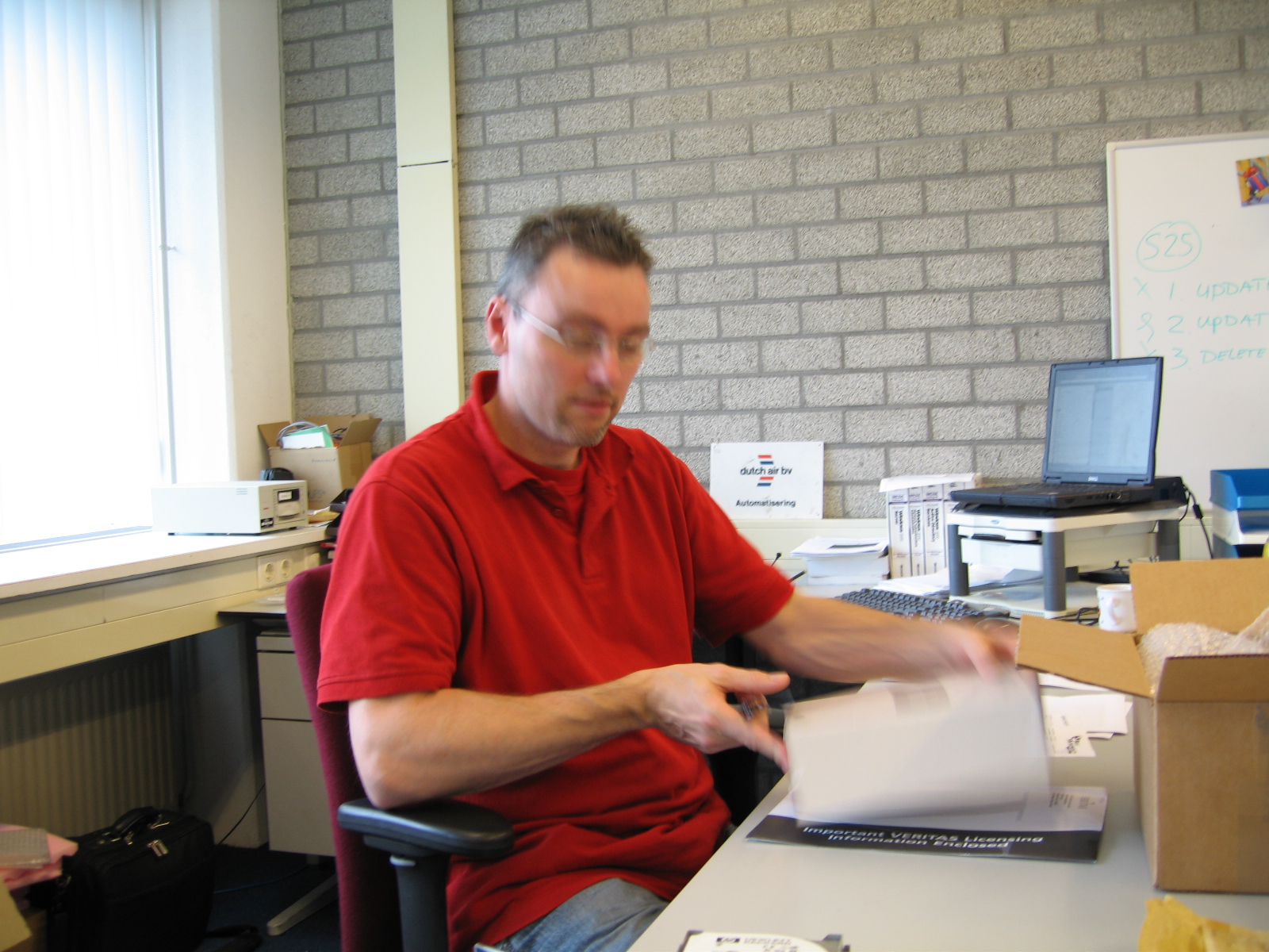 a man is looking over a paper on the desk