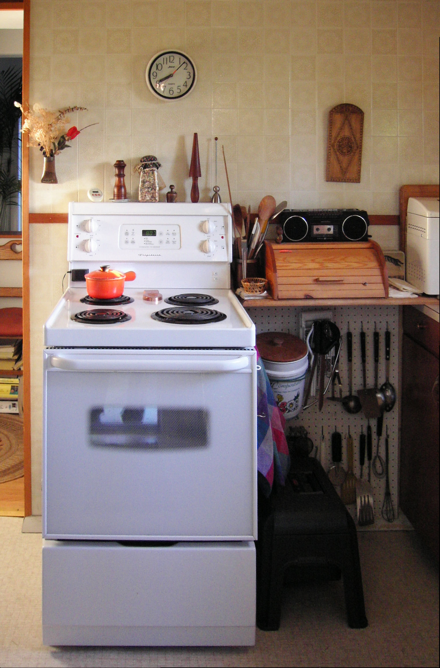 there are many tools on the shelf in the kitchen