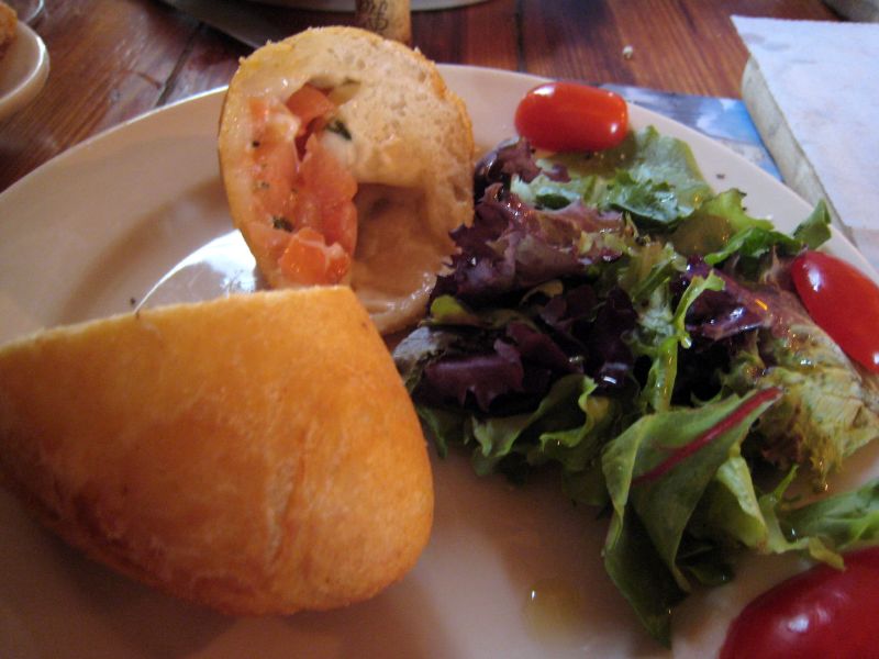 a sandwich with shrimp, tomatoes, and lettuce on a white plate