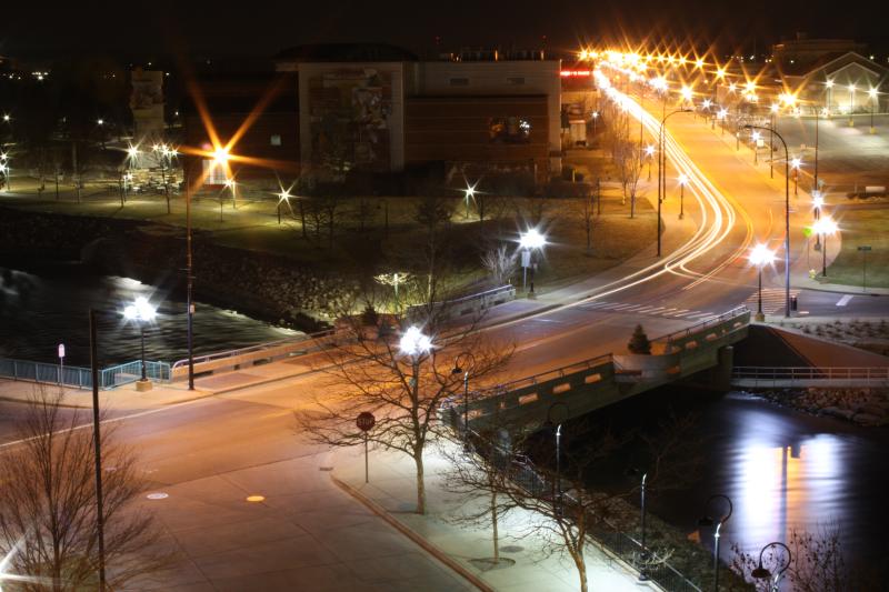 a nighttime view of a city street that has lights