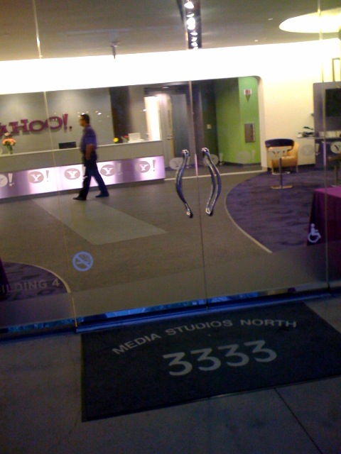 a person walking in front of a glass door at a museum