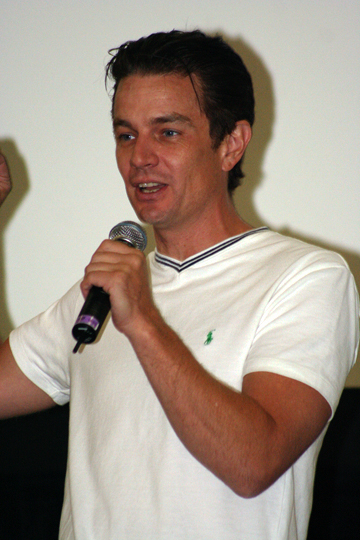 a man with a microphone giving a speech