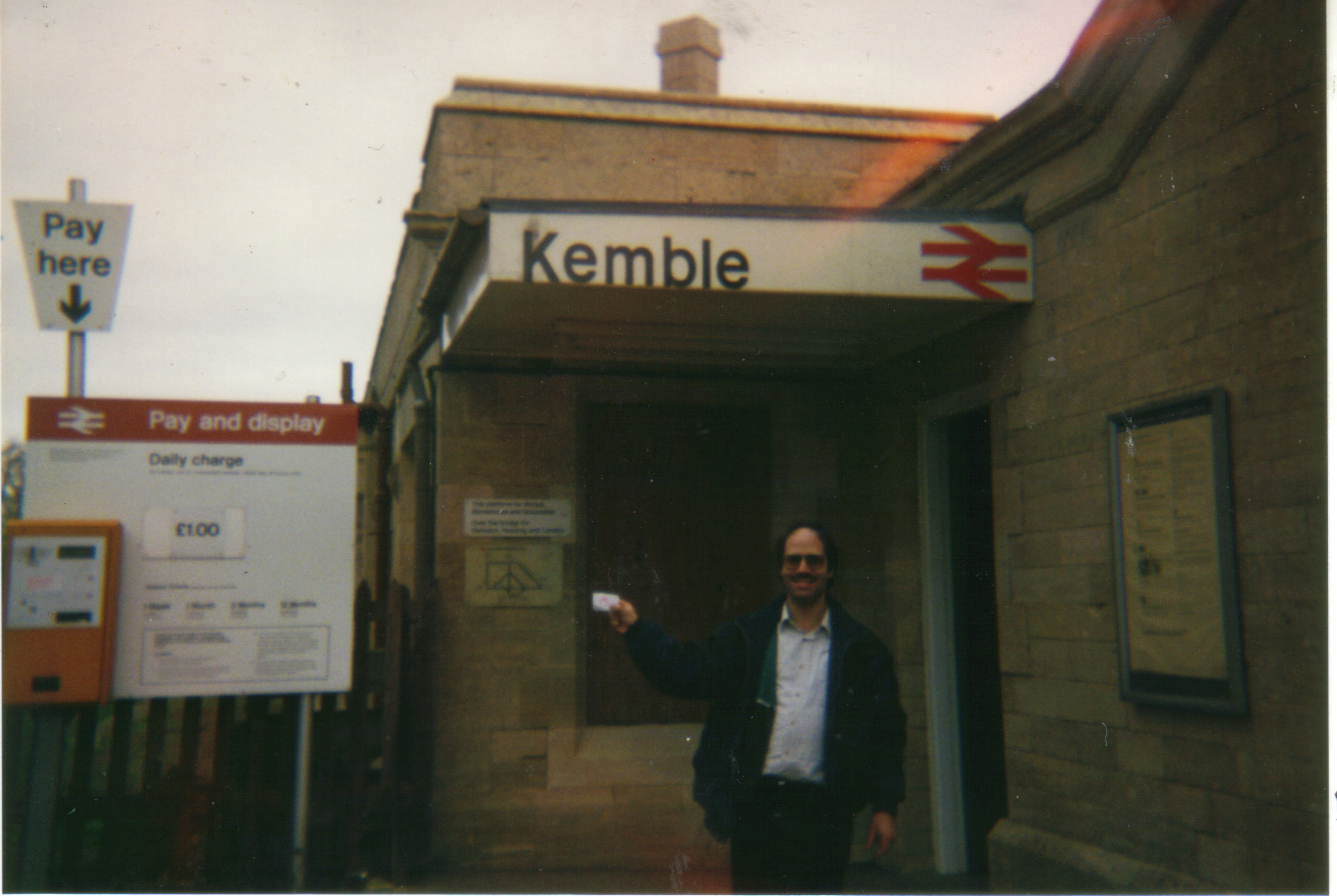 a man is posing for a po in front of a building