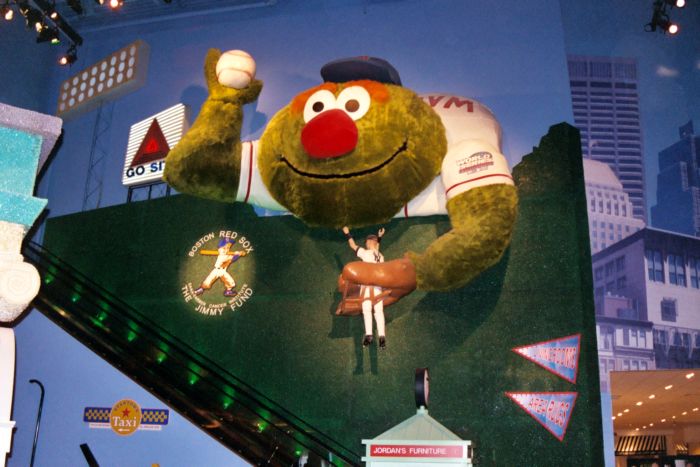 a baseball mascot posing with the crowd