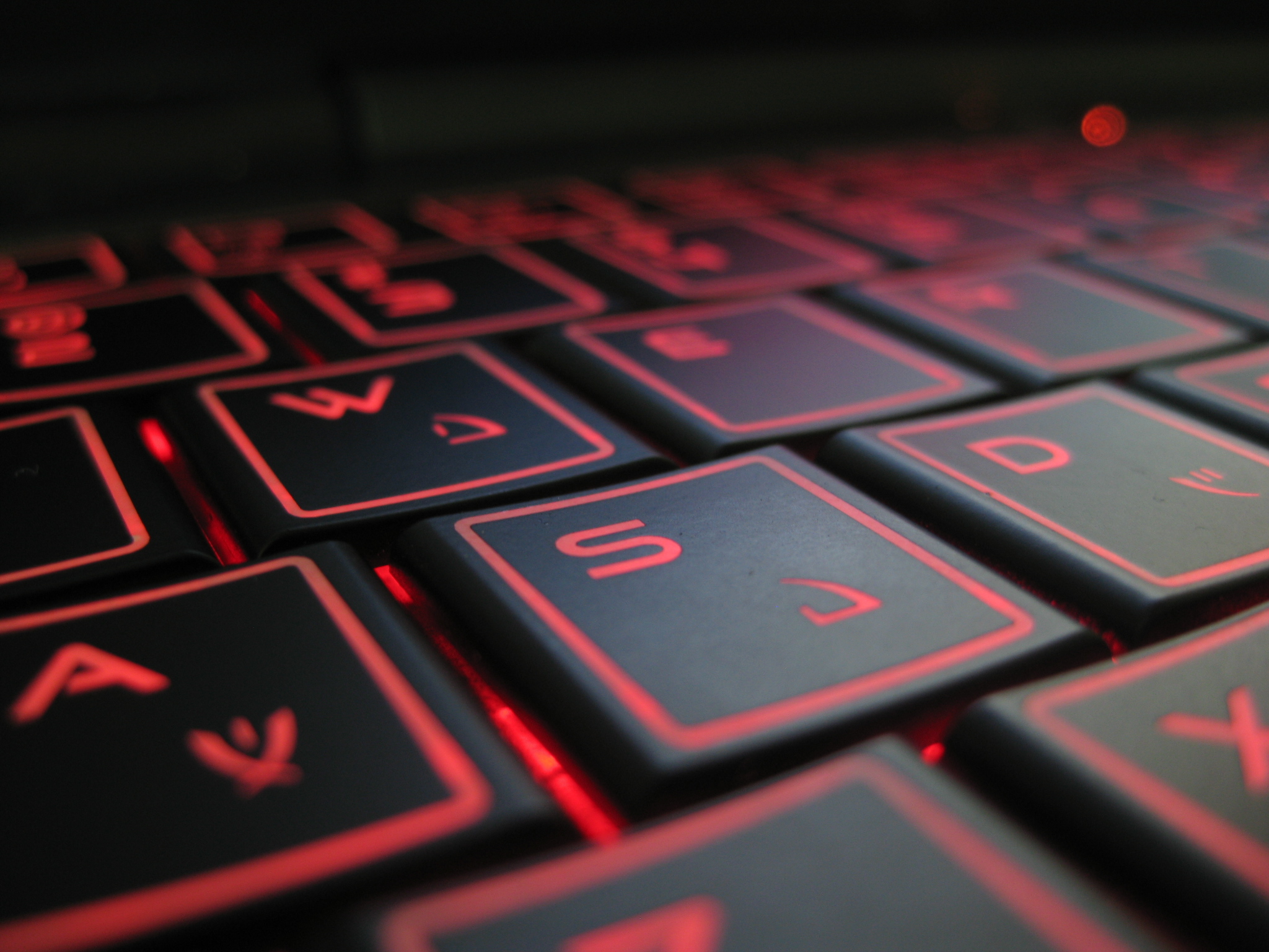 red led on the keys of a black computer keyboard