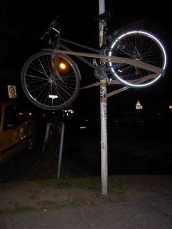 an old bicycle mounted on a light post