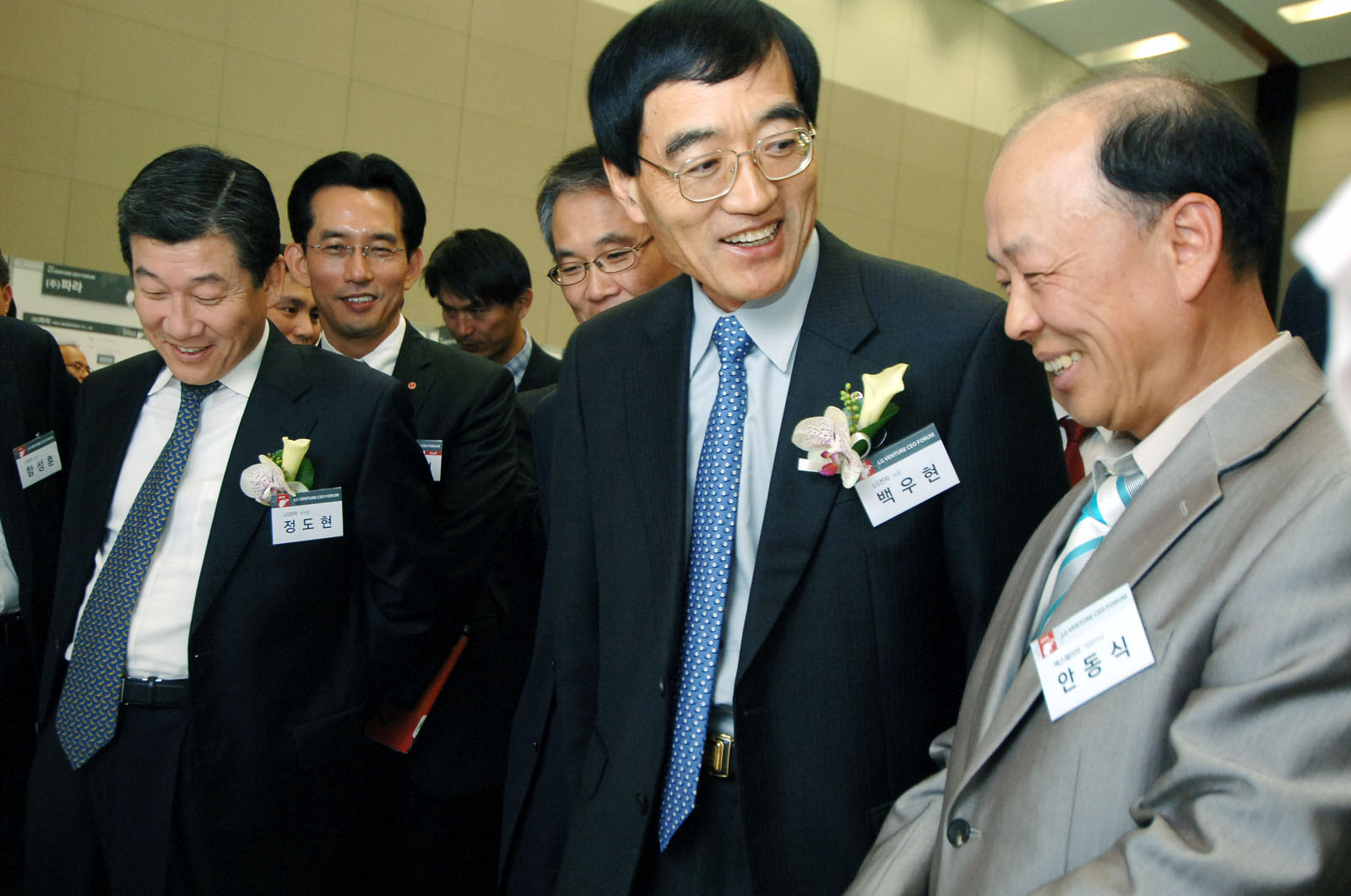 many men smiling and laughing together in formal wear